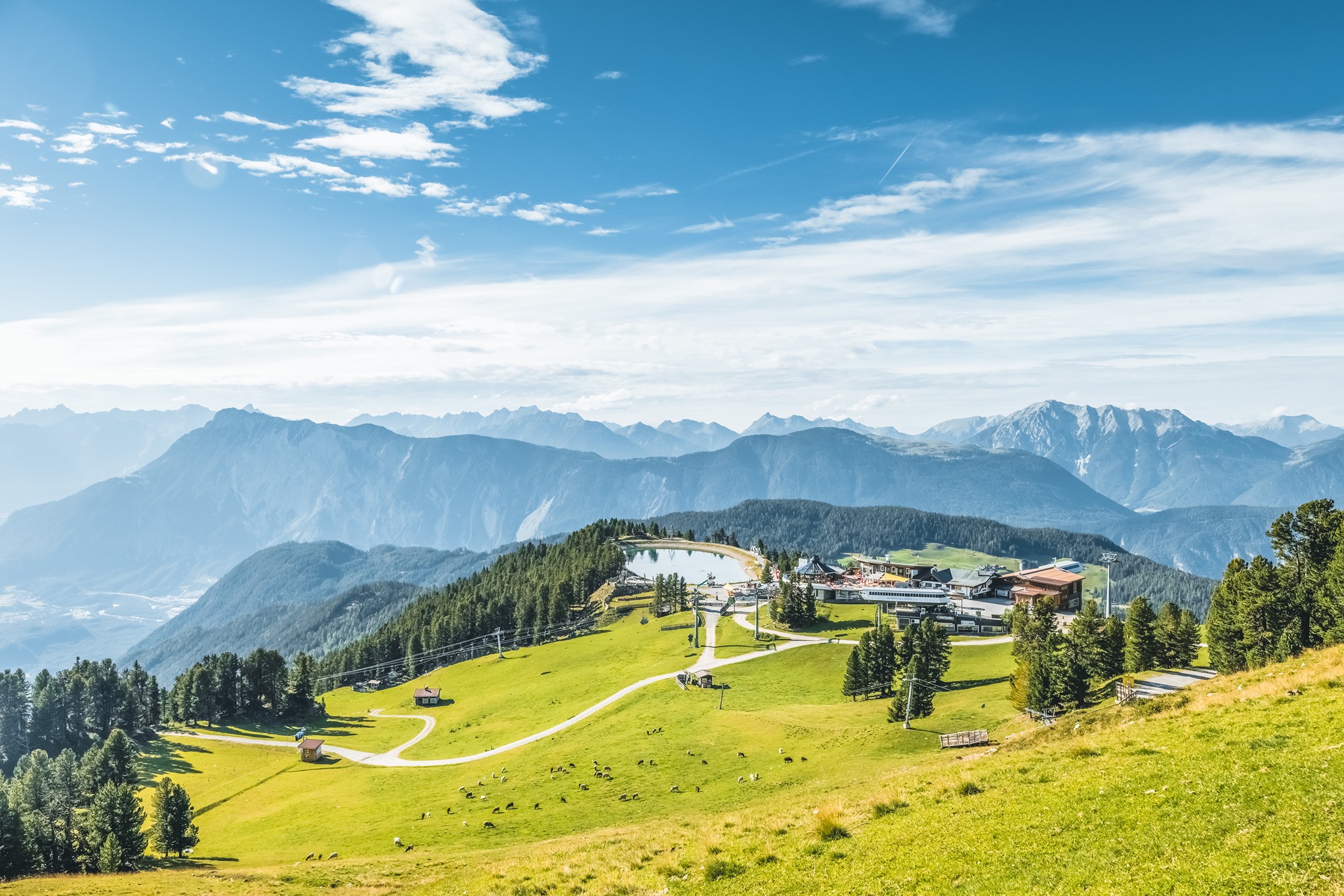 Groene alpenweiden met een bergmeer boven Oetz